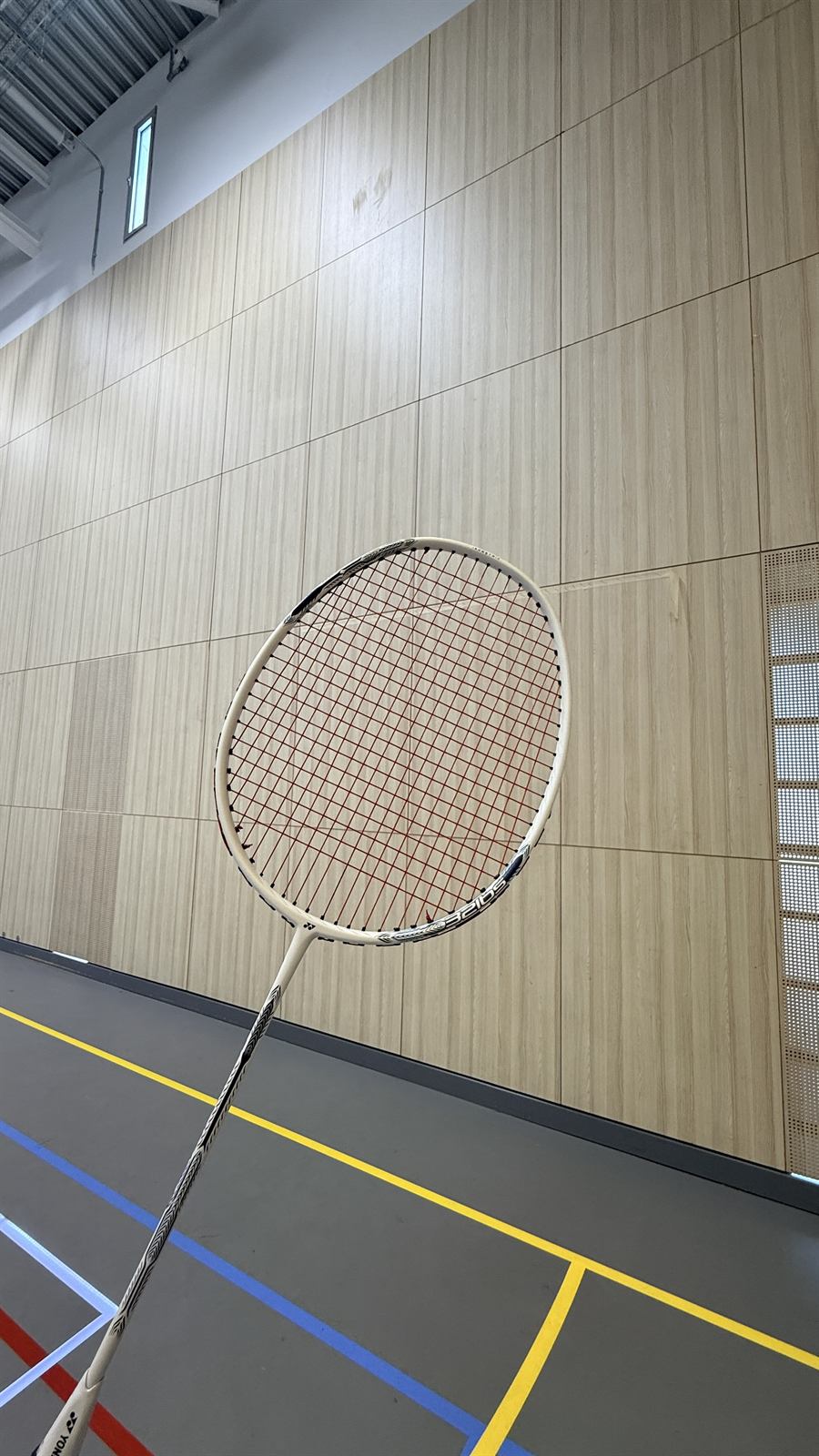 Yonex badminton racket freshly restrung with red and black strings by Slough Strings